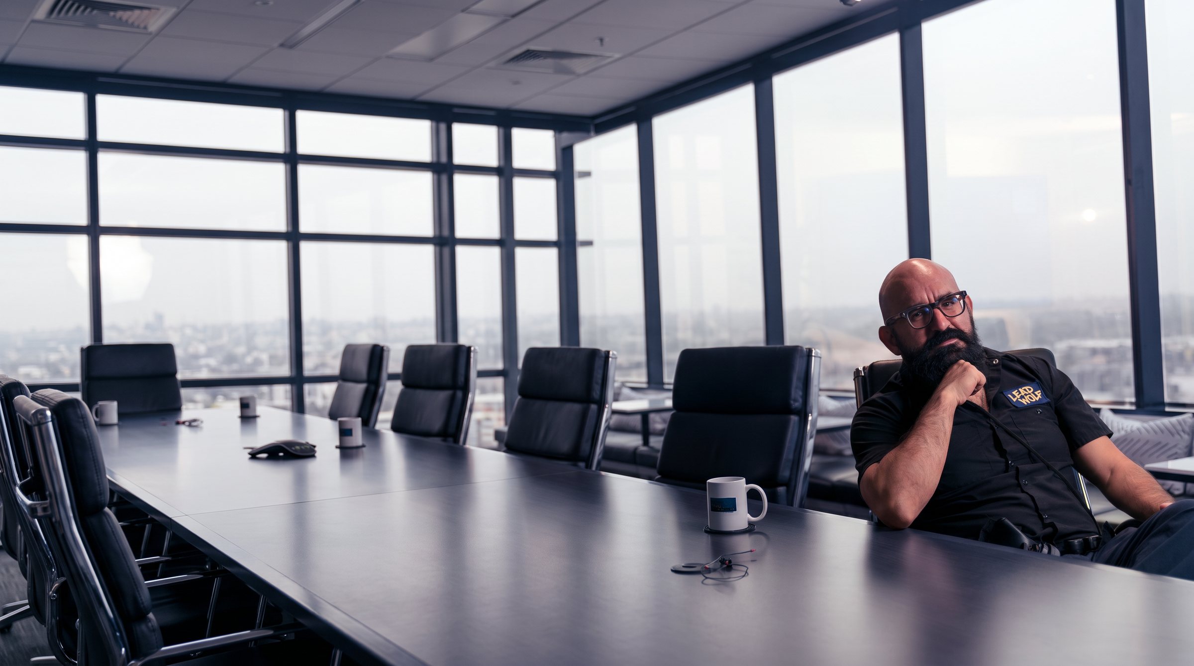 Oz Riveros thinking at a conference table