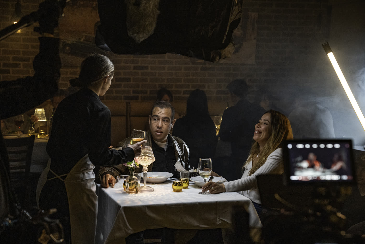 Filming a dinner scene for Fair Trade, the monitor in frame