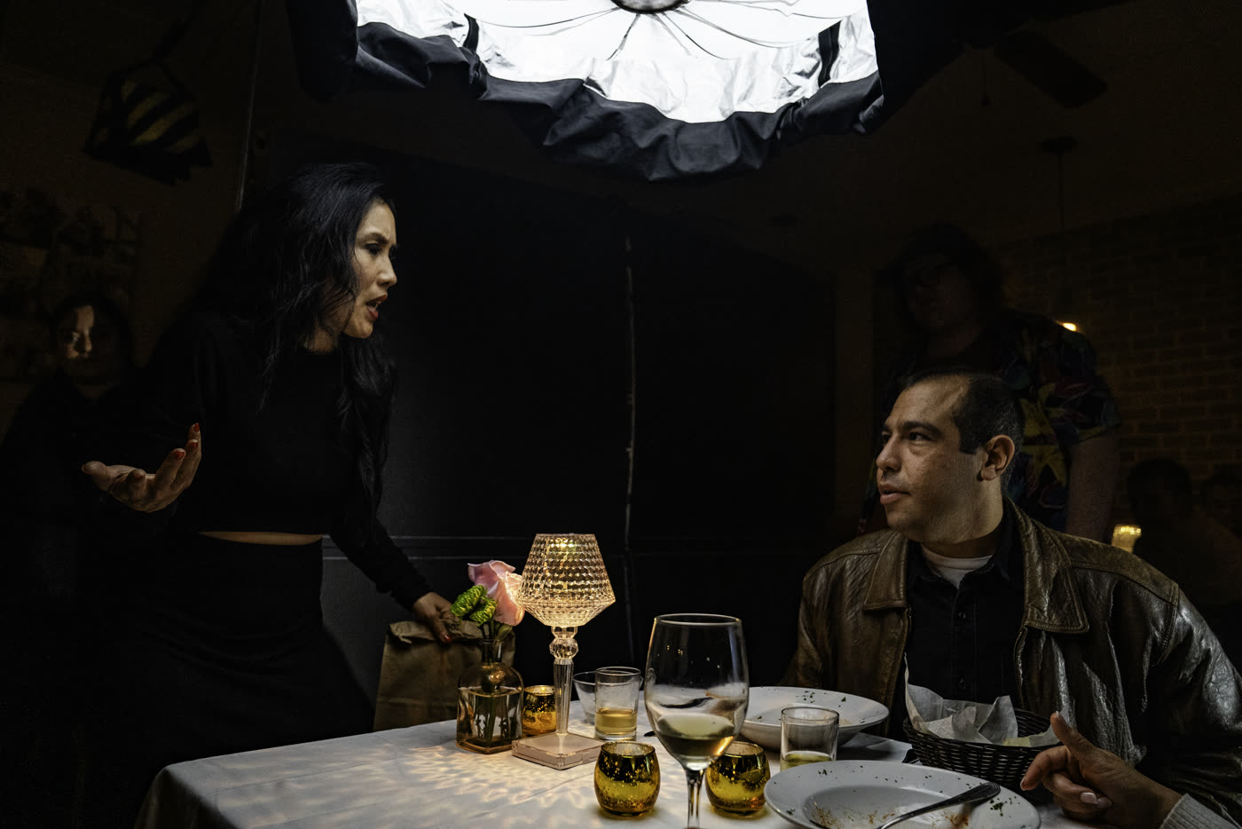 Actors rehearsing a dinner scene under a big softbox on Fair Trade