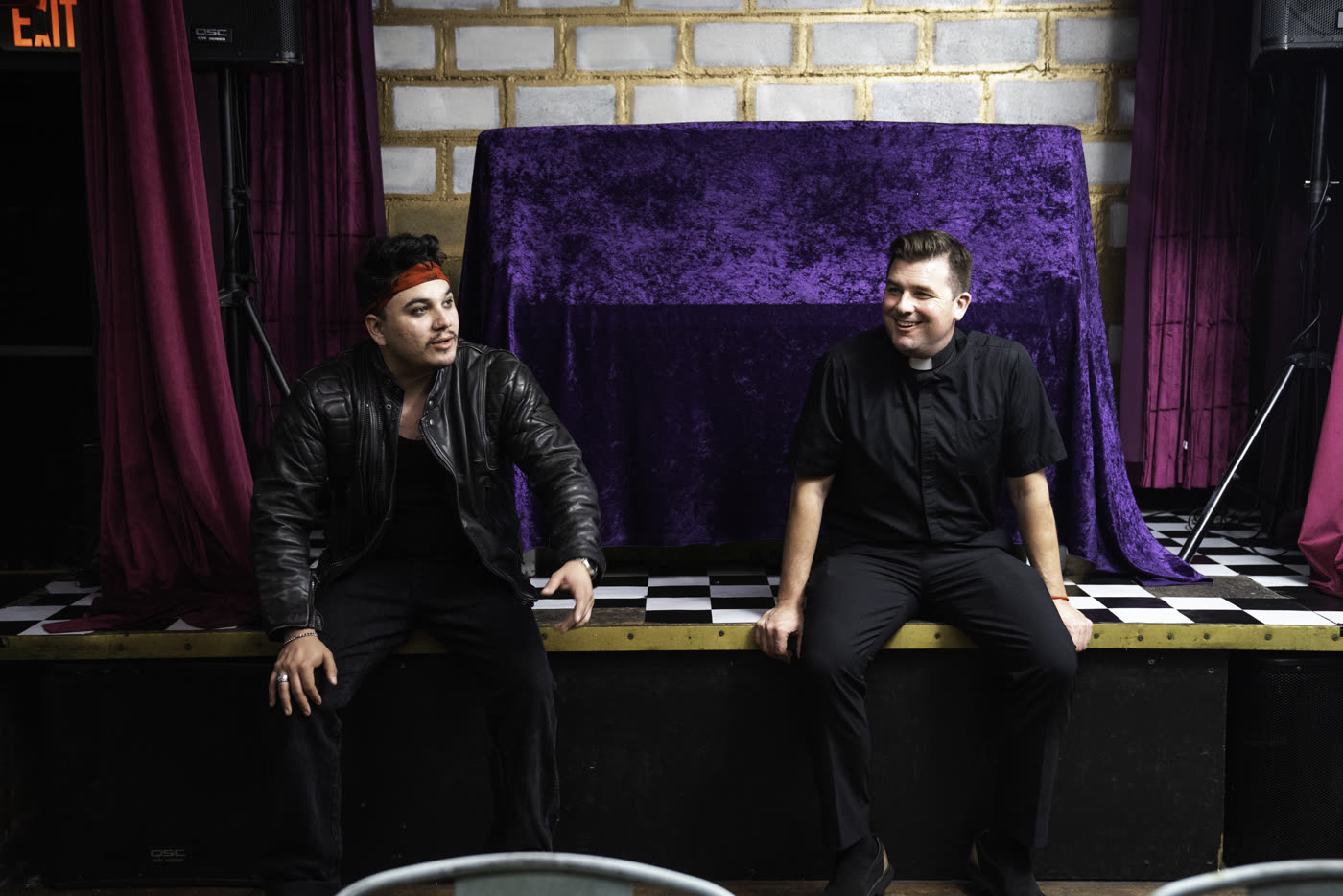 Two actors on the stage set of Fair Trade