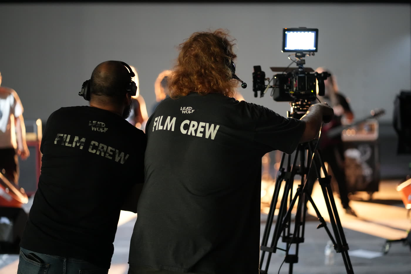 Oz Riveros and the crew at the camera on a warehouse music video set