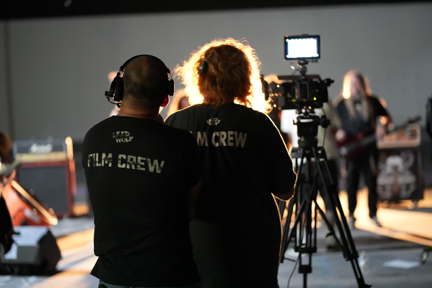 Two Lead Wolf Film Crew members watching a take in a warehouse