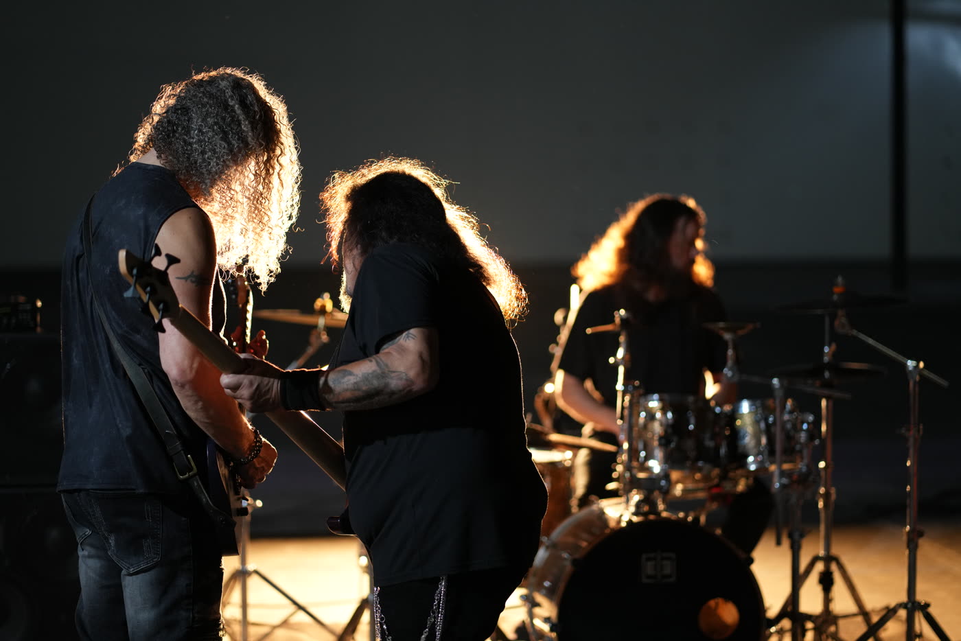 A band backlit on a warehouse music video set