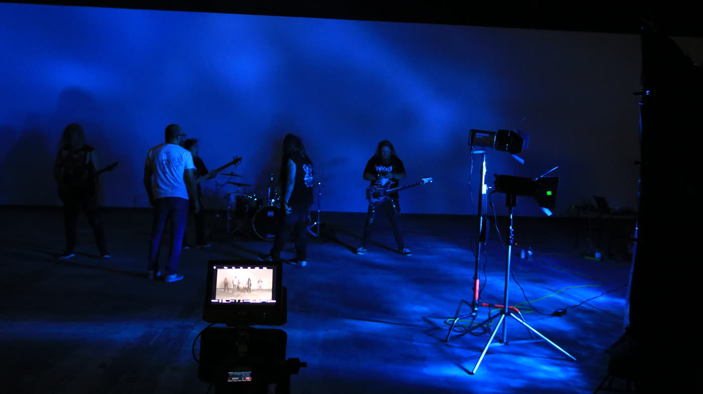 Band and camera under blue light in a warehouse