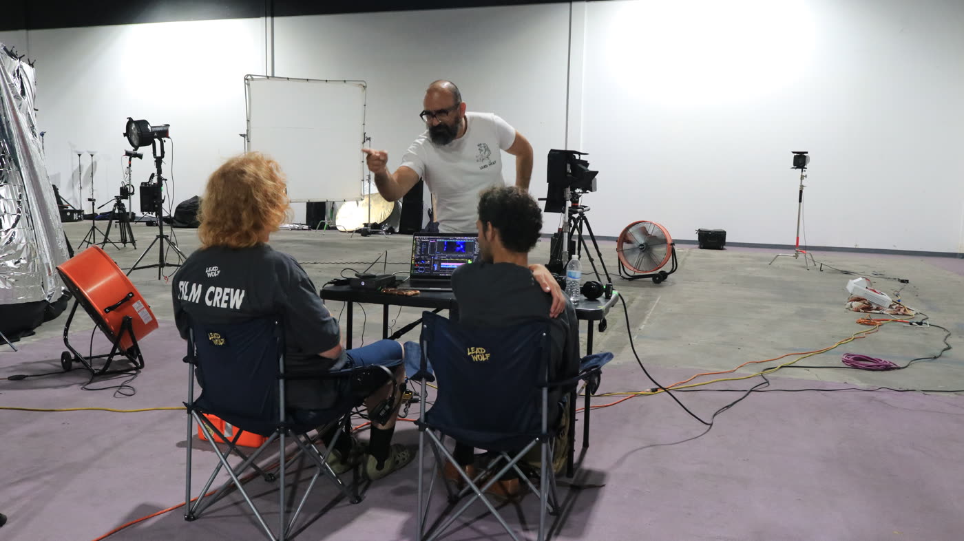 Oz Riveros and the crew at video village in a warehouse